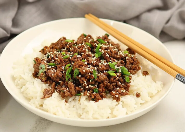 High-protein Korean ground beef rice bowl with white rice, sesame seeds, and green onions