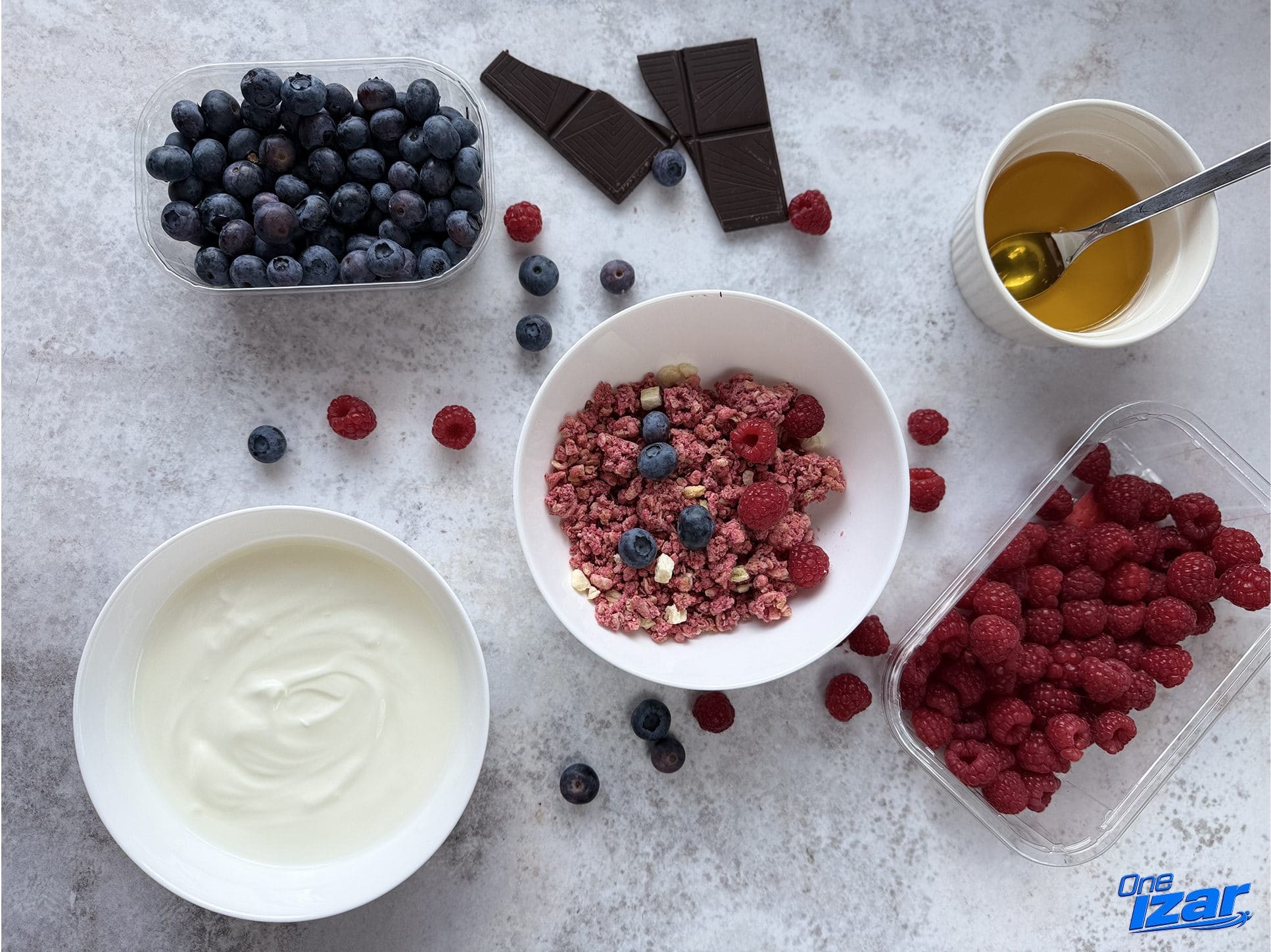 Ingredients for high-protein frozen berry yogurt bark: Greek yogurt, honey, blueberries, raspberries, dark chocolate and freeze-dried raspberry granola